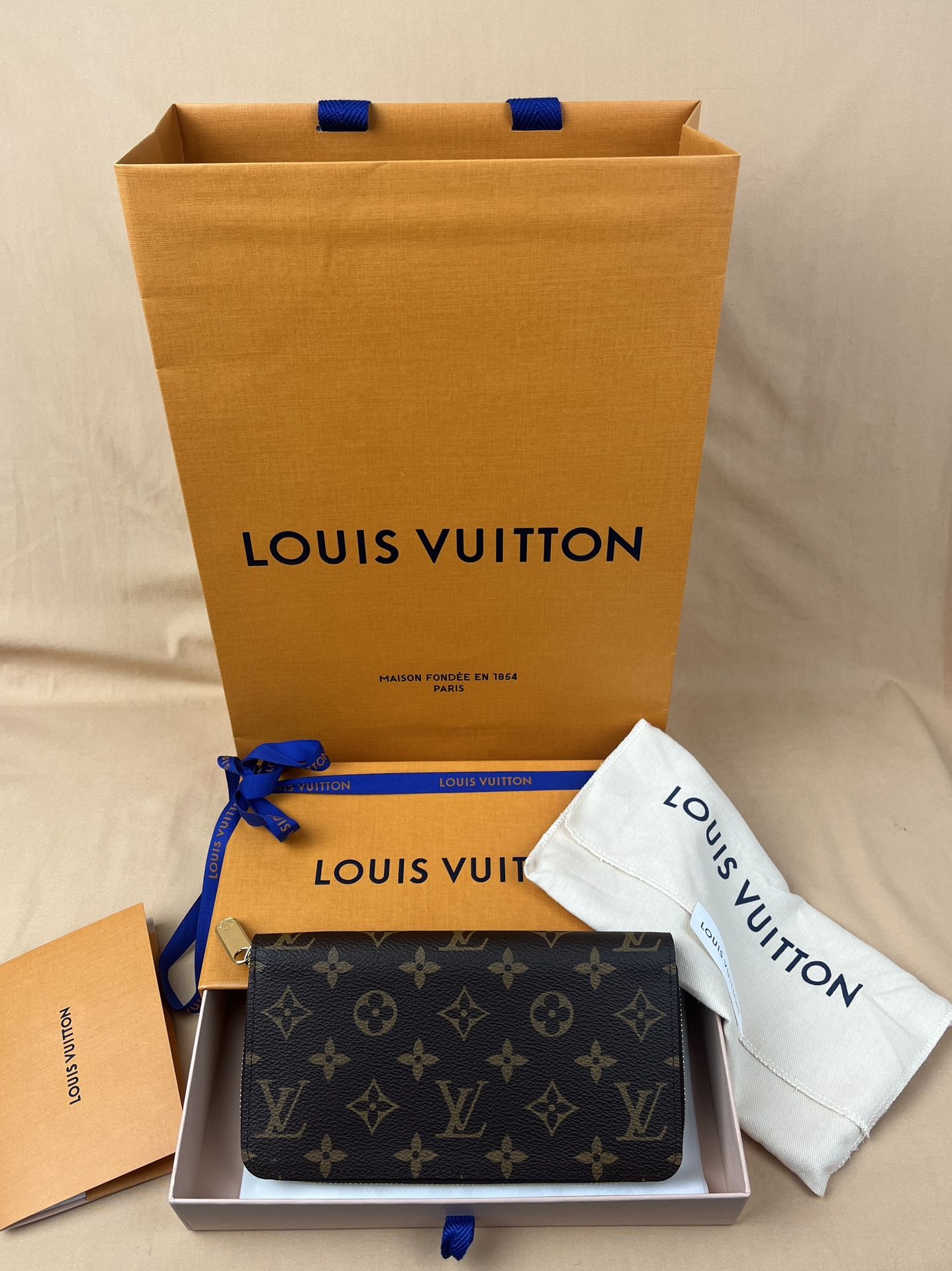 Authentic Louis Vuitton Zippy Wallet in Monogram Canvas and Fuchsia Interior