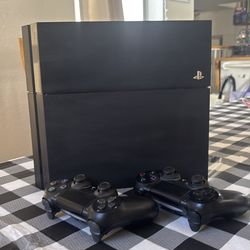 PlayStation 4 with 2 controllers and 3 games