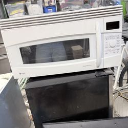 GE Profile 30” over-the-range convection microwave oven in white.
