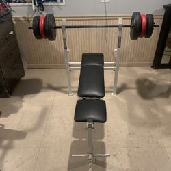 Small Bench For Beginners With Barr And 80 Lbs Plastic Weights And Clips 