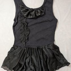 Free style Danskin, black dance leotard with an attached black skirt. Size 6 
