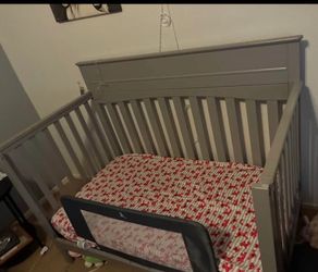 Gray Wooden Baby Crib and dresser