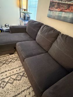Dark gray three seater couch