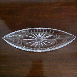 Vintage lead crystal boat-shaped dish with starburst and leaf cut patterns.