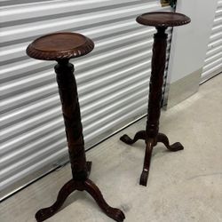 Two hand carved solid mahogany wood  stands. 42 “ high , 11 around  $300 for both