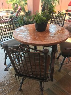 Wrought Iron Patio Table with 4 Chairs, cushions included.