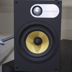 Bowers & Wilkins 686 bookshelf speakers, known for their yellow Kevlar drivers.