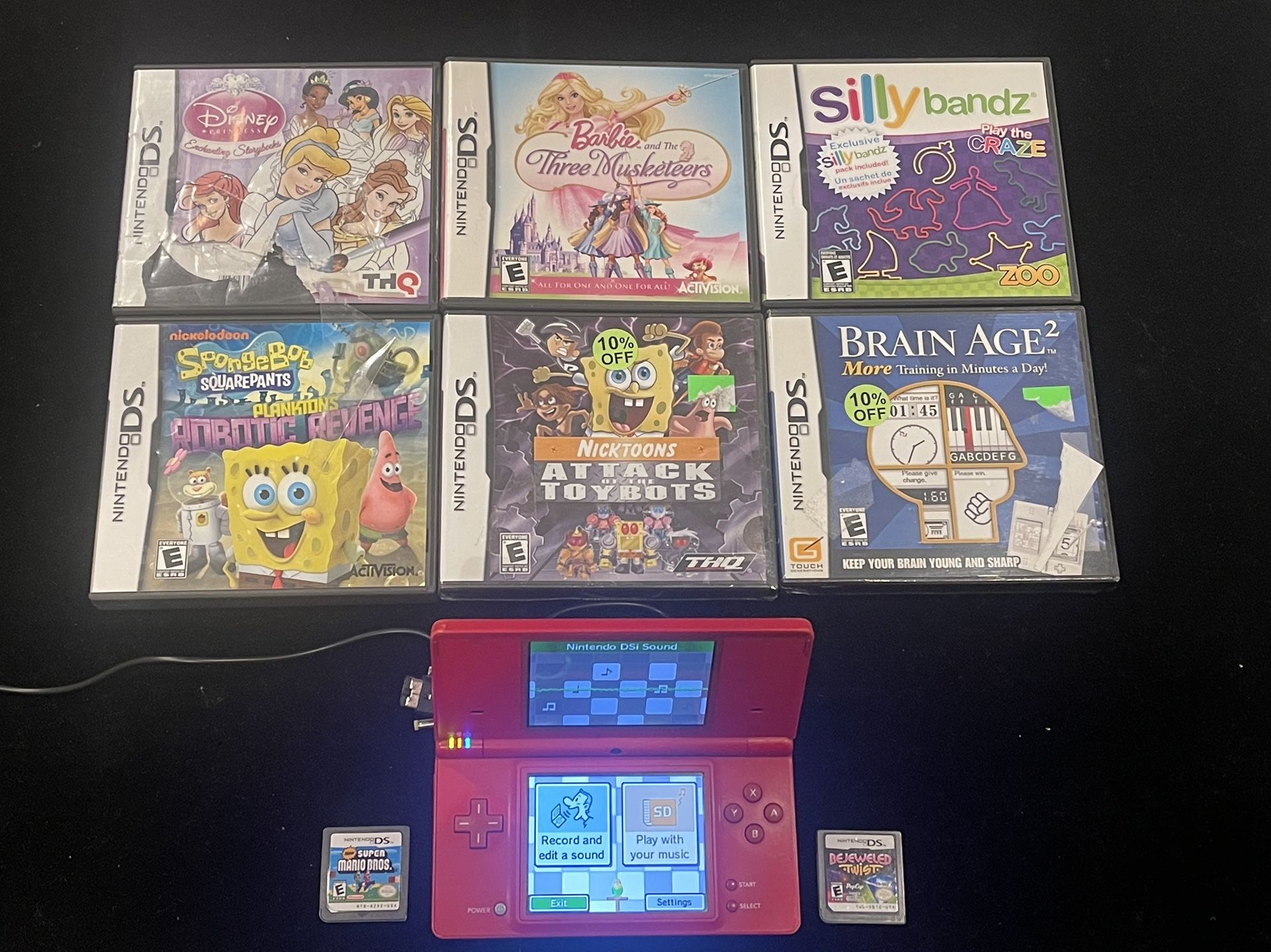 Nintendo DSi Pink Handheld Console System + Lot of 8 Games