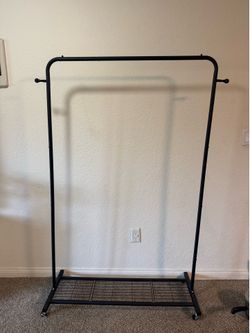 Clothes hanging rolling rack. Black. Used once.  Pick up only in Cardiff