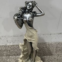 vintage-style collectible figurine depicts the Goddess Ostara, symbolizing spring, rebirth, and fertility.