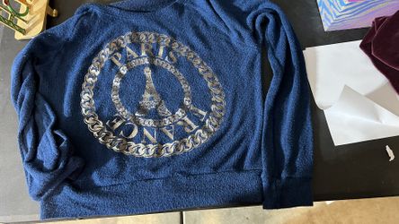 Navy blue shirt with a gold-ish, silver PARIS 