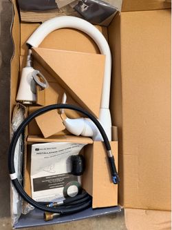 New Glacier Bay pull-down kitchen faucet in white. This unit has a high-arc spout and includes a black braided hose, installation guide, and mounting 
