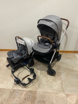 Nuna Triv Stroller with Car Seat with white canopy
