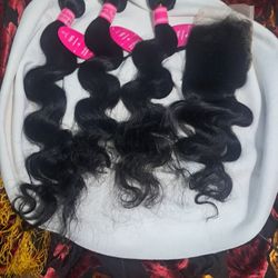 One hundred percent real human hair bundles with a full closure top piece