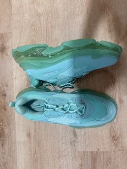 Those look like Balenciaga Triple S Clear Sole sneakers