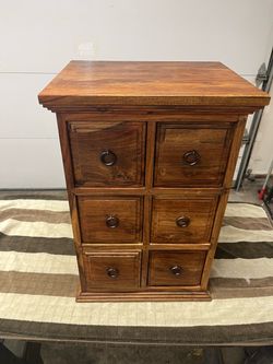 6-drawer apothecary-style chest or nightstand made from solid Sheesham wood (also known as Indian Rosewood).