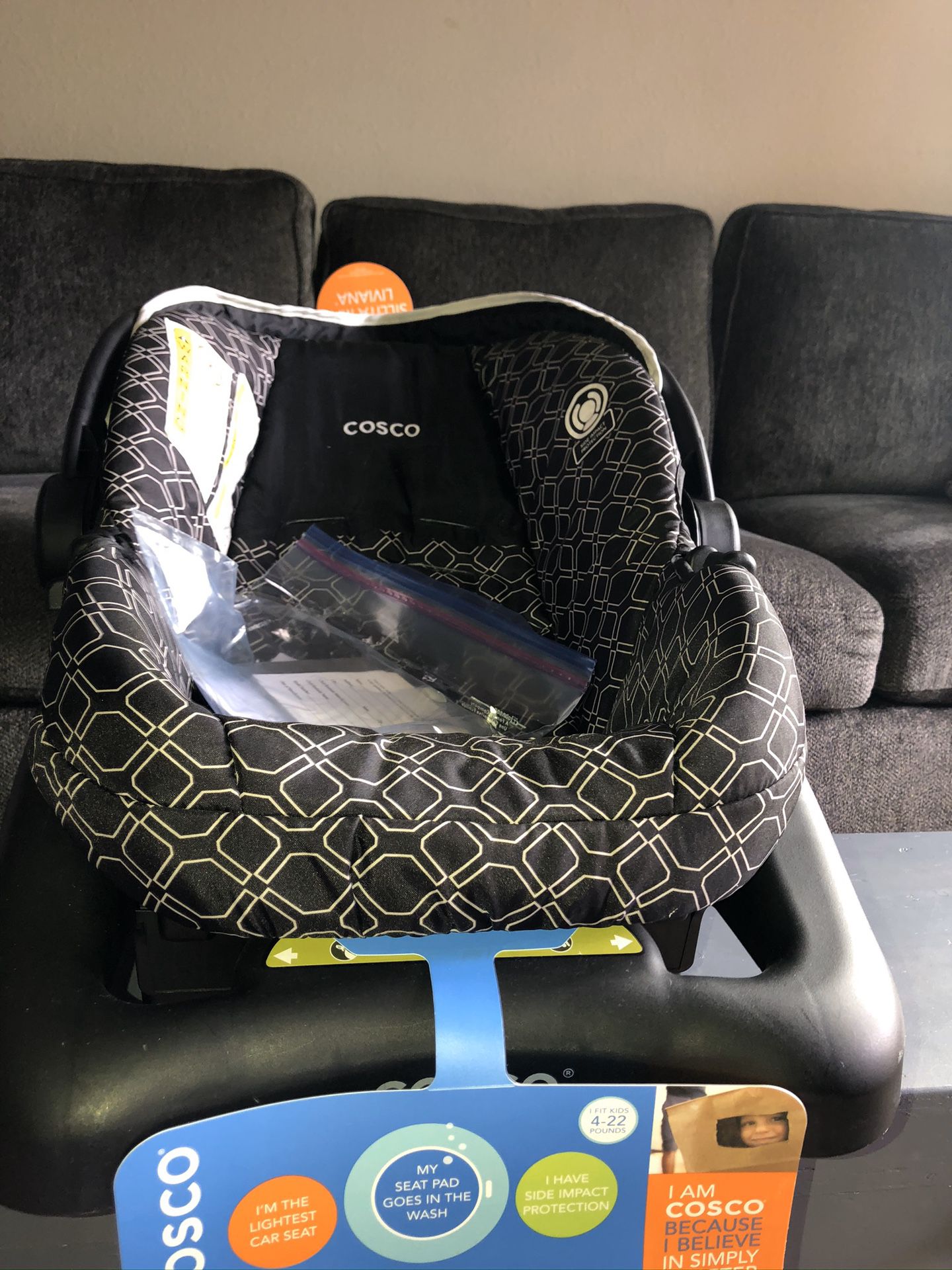Brand New/ Never Used Cosco Rear Facing Car Seat with stand.