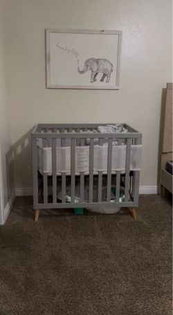 Grey mini crib and picture frame $50