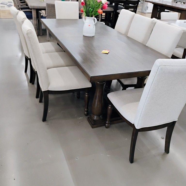 Dining set featuring a large rectangular dark wood table paired with six
