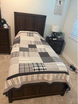 Twin bed frame includes mattress