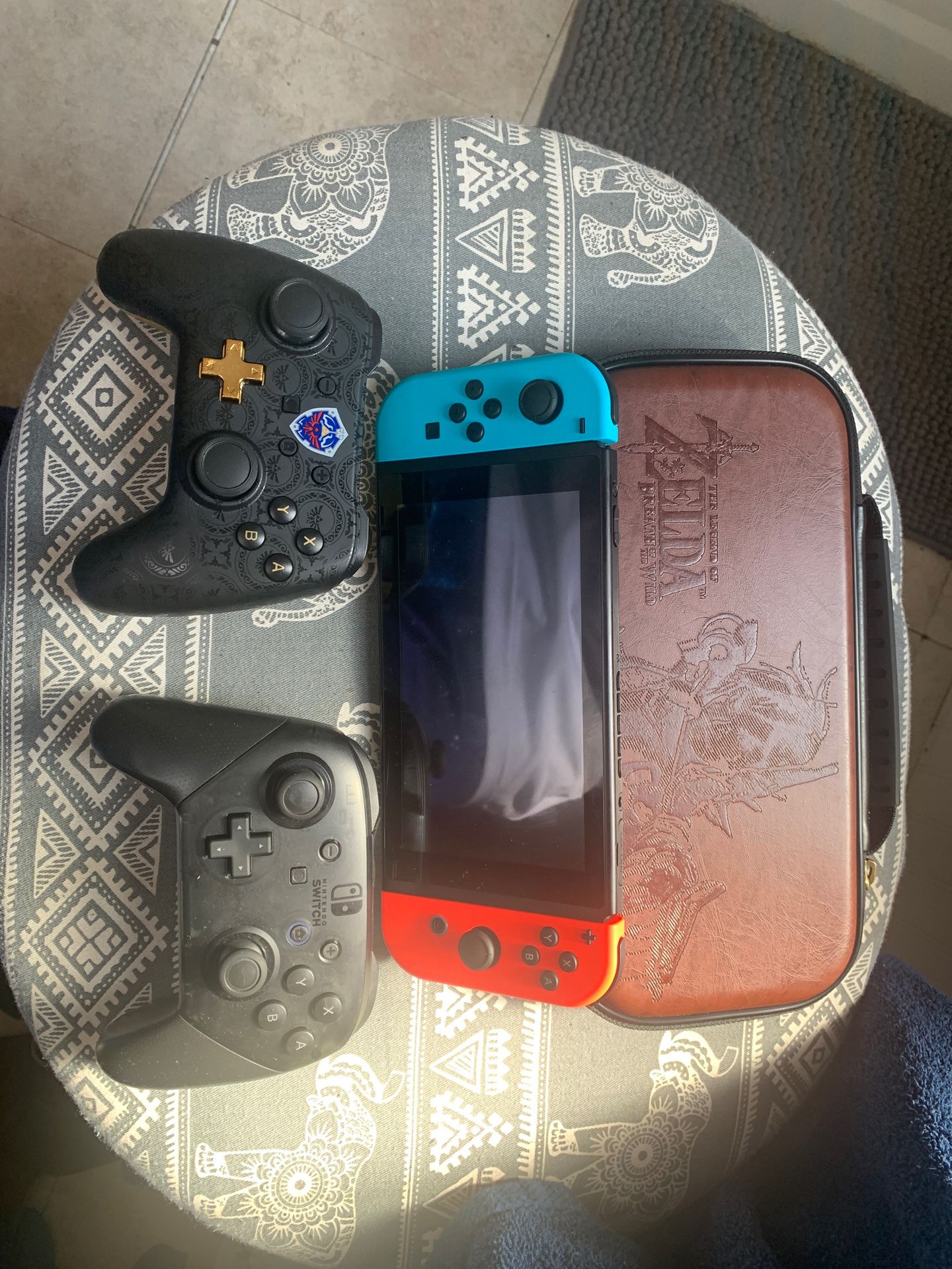 Nintendo Switch (used less than 5 times). Super smash bro, Mario Kart. Pro controller, wired Zelda controller. With Zelda case