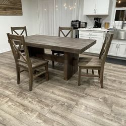 Rustic farmhouse style real wood dining table with matching 4 chairs (72” x 39” x 31”). In Excellent Condition.  