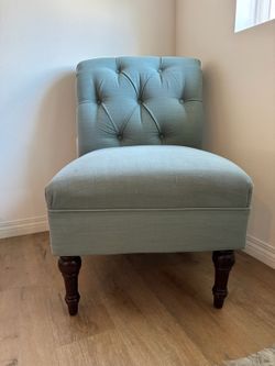 Tufted blue armless chair