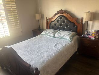 Full wooden Queen bed frame with Mattress and double dresser featuring a matching ornate arched mirror ,and  x two-drawer wooden nightstand.