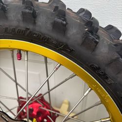 DNA x Racing Series 21/19" gold dirt bike rims and tires with red hubs