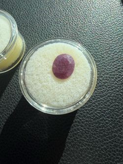 oval-cut, purplish-red Ruby Cabochon gemstone