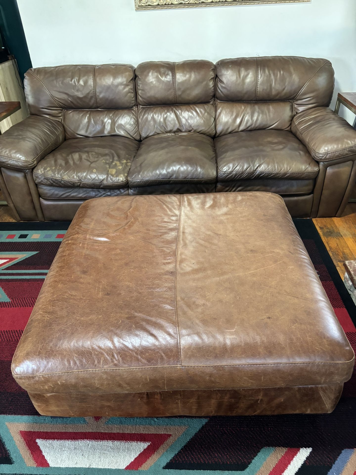 Leather couch and ottoman with two side tables
