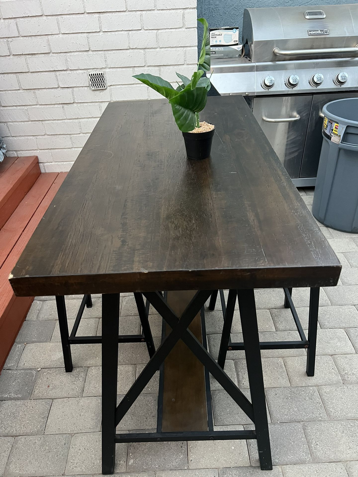Attractive counter height table with two stools
