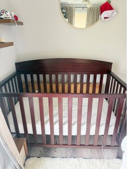 Darkw brown wooden baby crib