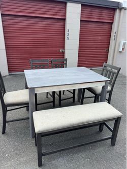 Wooden high table and four chairs and a bench