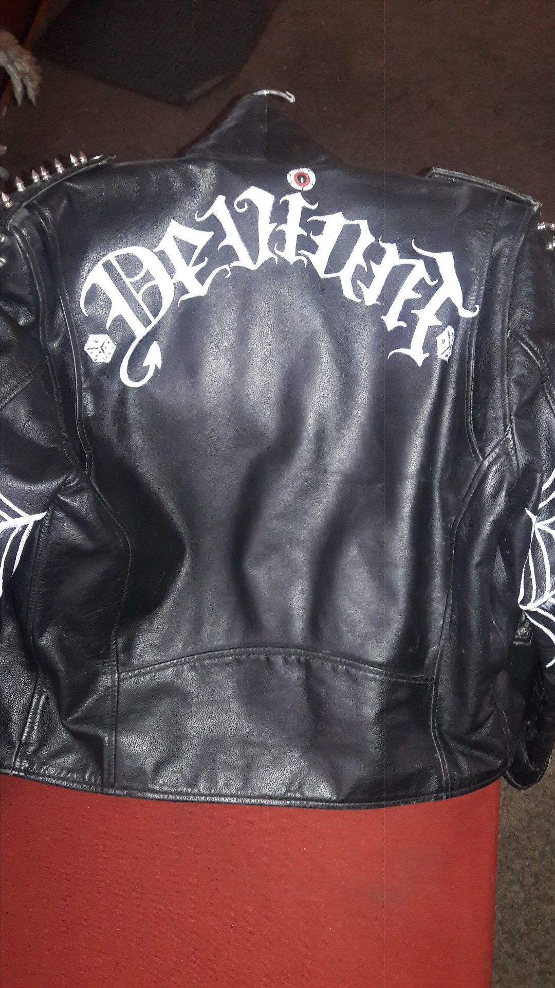 Studded black leather Jacket with the words "Deviant" on the back