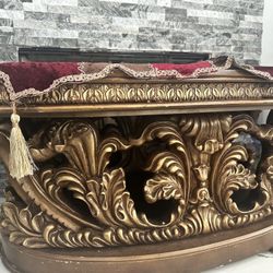 A large, beautifully carved sofa with intricate details. It's a very beautiful piece.