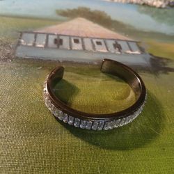 Mark. (or Lia Sophia) gunmetal-tone cuff bracelet enhanced with clear baguette-cut crystals. 