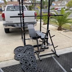 Squat rack/ bench press with 7ft 45lbs bar with 295lbs plus weights free