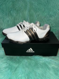 adidas Tech Response men's athletic golf shoes in white with black trim. Lace-up closure for a secure fit. Cushioned interior for comfort. Durable bla