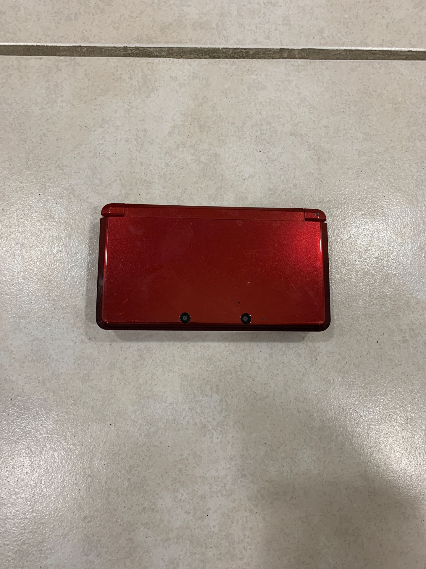 red Nintendo 3ds with no charger or stylus, Pokémon game included