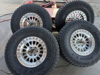 17x9KMC IMS SILVER MACHINE 6x139.7+35x12:50R17 ATLAS XT TIRES