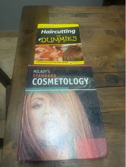 Milady standard cosmetolog books and Haircutting books