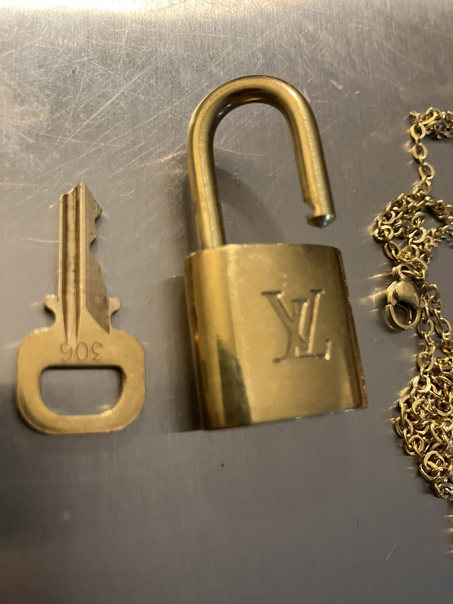 Authentic Louis Vuitton individually numbered lock with key