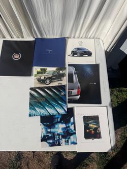 Cadillac car brochures from the 90s to 2000s