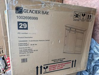 Glacier Bay 31 in. x 29 in. Wooden Medicine Cabinet with a sliding barn door mirror.
