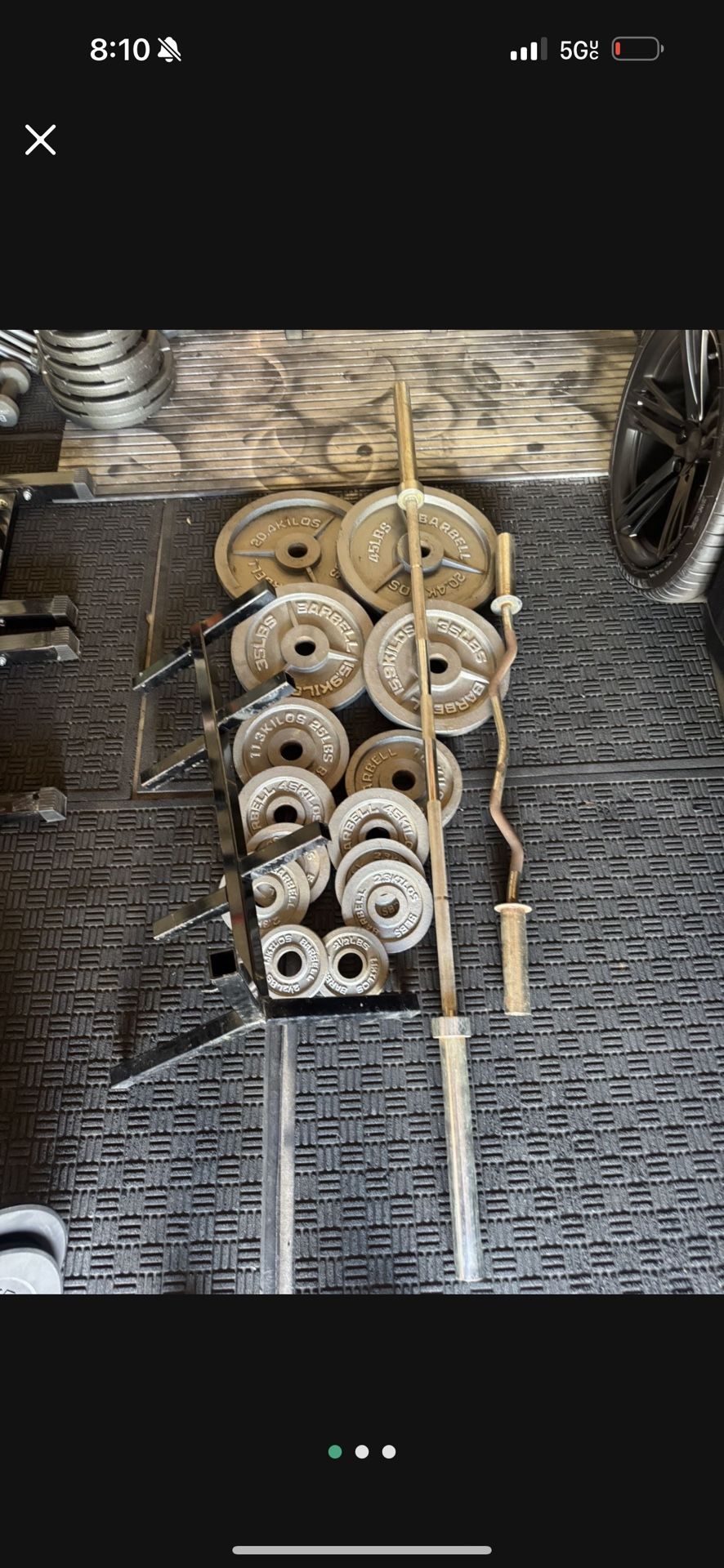 Olympic weights 255lbs total plus 7ft 45lbs bar plus curl bar and weights tree