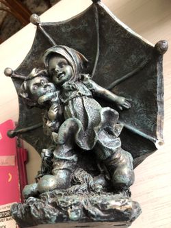 SMALL BOY AND GIRL UNDER UMBRELLA