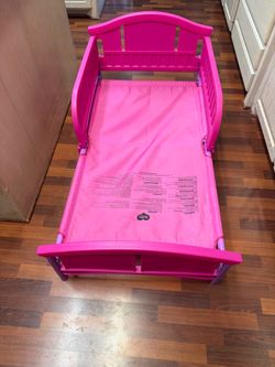 Pink plastic toddler bed 53.94"L x 29.13"W x 26.18"H  fits crib mattress