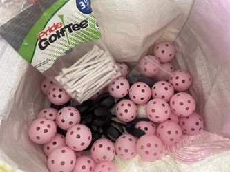 Golf Tee and Pink Practice Balls