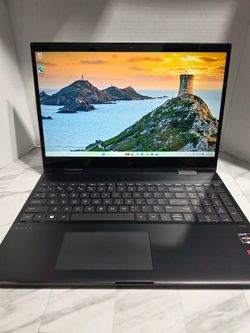 CARBON FIBER BLK HP Envy x360 convertible aluminum body laptop with a full HD display, backlit keyboard, numeric keypad, and AMD Ryzen processor. Runn